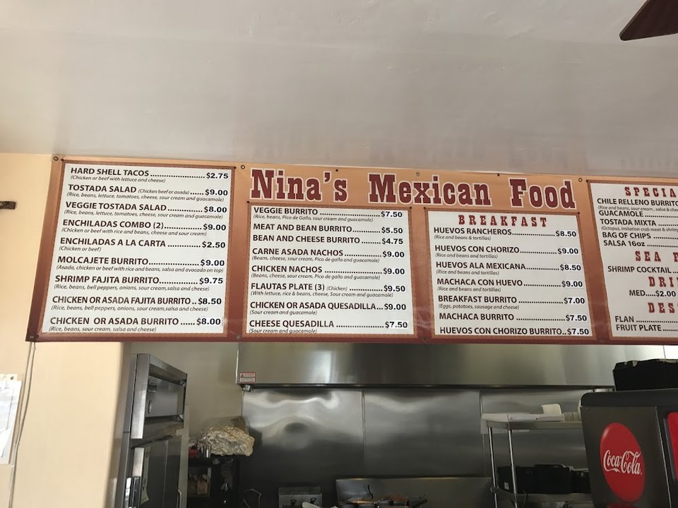 Counter menu with tacos, plates, and breakfast items.